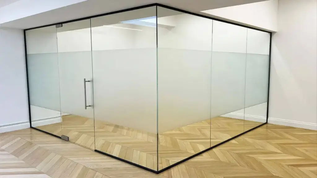 frameless glass partition with frosted panels in modern interior design